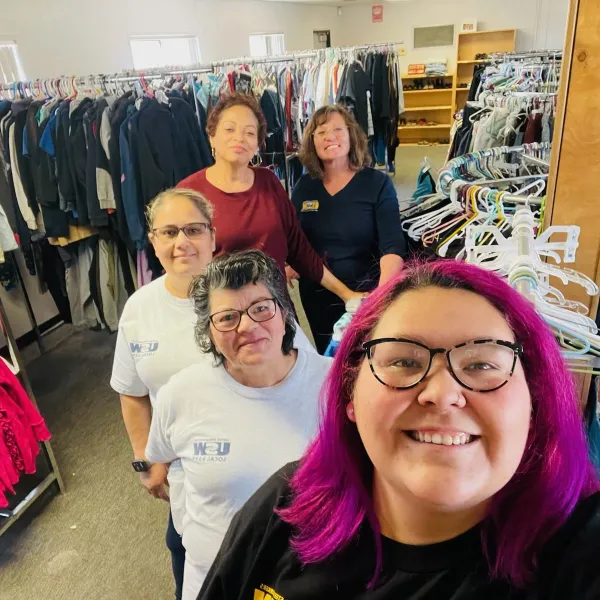 The Women of Steel Committe with racks filled of organized donations.